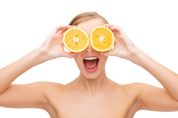 amazed young woman with orange slices