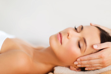 beautiful woman in spa salon having facial