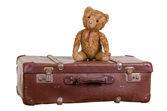 Old Teddybear Sitting On Suitcase