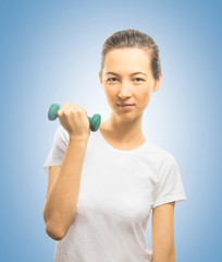 Woman smiles with a dumbbell