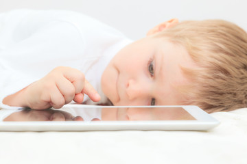 Little boy with touch pad