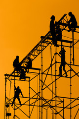 Silhouette of Workmen on assembling concert stage