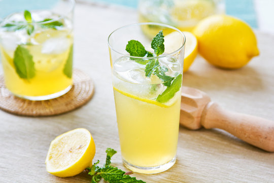 Lemonade with fresh lemon and mint by lemon reamer