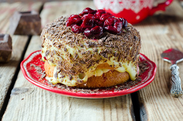 Sponge cake with cream, cherries and chocolate