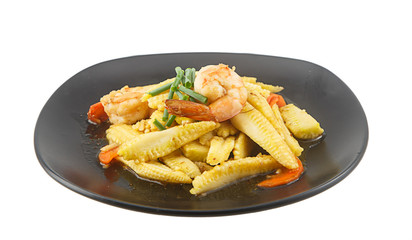 Stir fried baby corn and shrimp on dish isolated on white