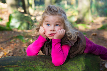 little girl is resting in the nature