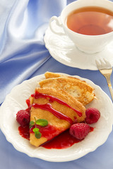 Delicious pancakes with berries  and raspberry sauce.