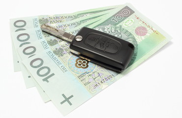 Heap of money with car key on white background