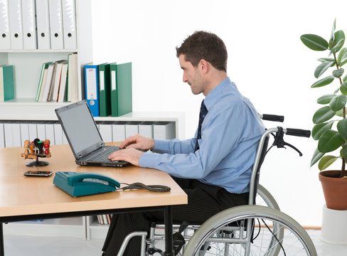 man in wheelchair on his workplace