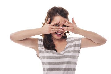Shy woman hiding behind fingers