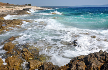 Fototapeta na wymiar Powerful waves crushing on a rocky beach