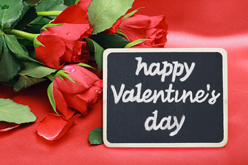 roses and a blackboard with congratulations happy valentine