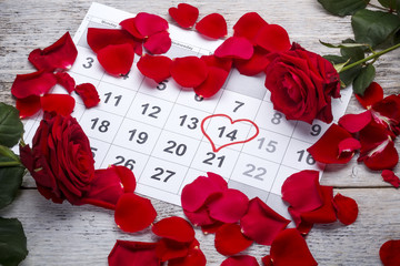 Red roses lay on the calendar