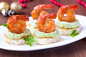 Shrimp on toast with guacamole sauce, Christmas appetizer