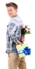 Handsome young man with flowers and gift, isolated on white