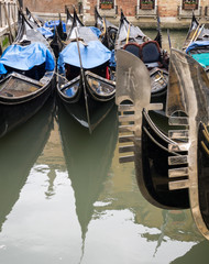 Fototapeta na wymiar Prows and sterns of Venetian gondolas