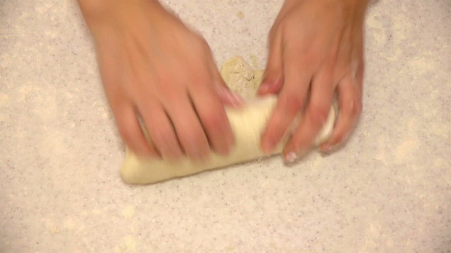 Woman kneading dough with hands for pizza