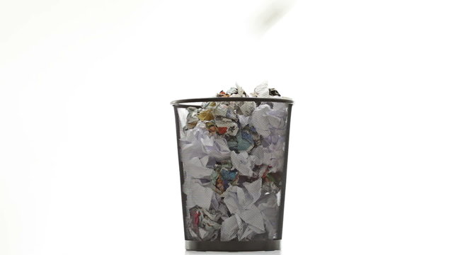 Throwing paper into the waste basket: Bin filled by documents