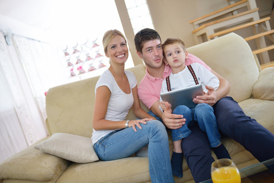 family at home using tablet computer