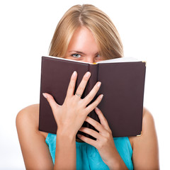 Close up of young woman reading book