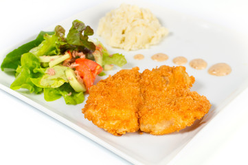 Fried fish with salad and mashed potatoes.