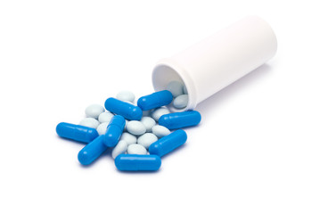 Light Blue and Blue Pills Spilling from Container