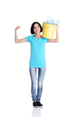 Beautiful young woman holding recycling bin