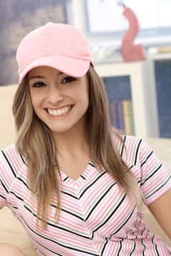 Sporty girl in baseball cap smiling