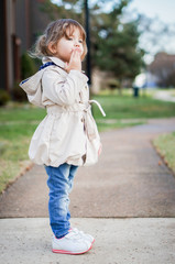 Cute fashionable baby girl smiling outdoors