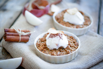 Apple crumble dessert with cinnamon and vanilla ice -cream on wo