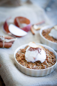 Apple crumble dessert with cinnamon and vanilla ice -cream on wo