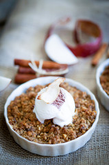 Apple crumble dessert with cinnamon and vanilla ice -cream on wo
