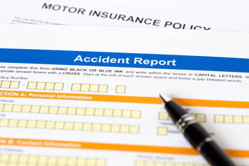 Motor or car insurance accident report form with pen