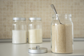 Three containers with breadcrumbs, flour, semolina