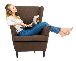 Young girl with headphones listen music on chair