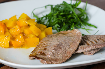 Grilled meat with pumpkin and ruccola