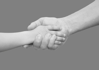 hands of father and son on a gray background