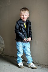 portrait of little stylish boy outdoors