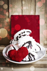 Meringue cookies and red heart/ Sweet holidays desert