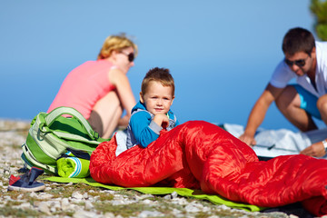 kid with parents camping in mountains © Olesia Bilkei
