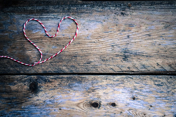 Heart made of knits on rustic wooden background