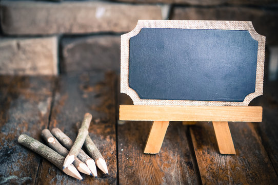 Vintage board and wooden pencils on rustic background