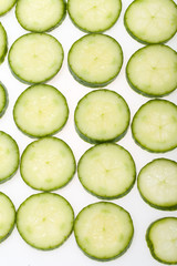 Freshly sliced cucumber  isolated on white background