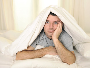 man in bed with eyes opened suffering insomnia sleep disorder