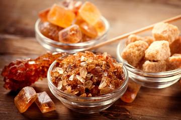 Sugar. Brown Sugar on a Wooden Background