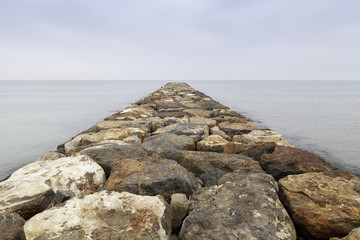 Fototapeta na wymiar dike rocks in the sea