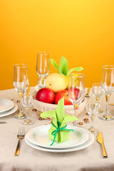 Table setting in green and yellow tones on color  background