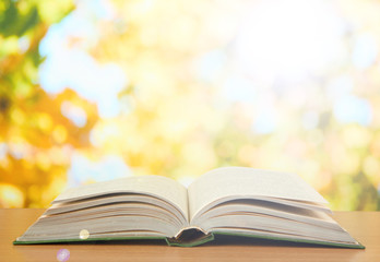 Opened book on bright background