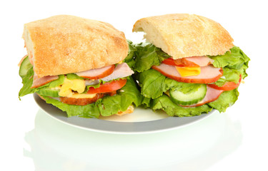 Sliced sandwich with ham and vegetables isolated on white