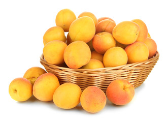Naklejka na ściany i meble Fresh natural apricot in wicker basket isolated on white